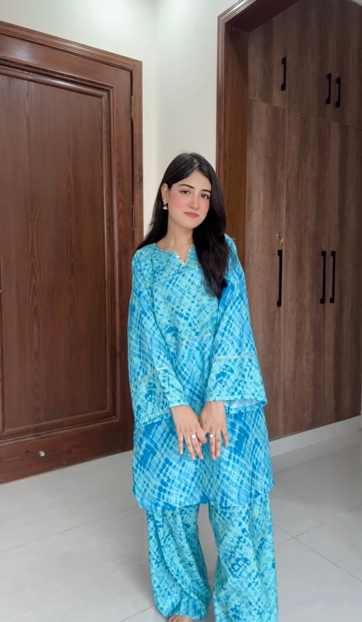 Wide-leg farshi shalwar paired with teal bandhani kurta for women Pakistan